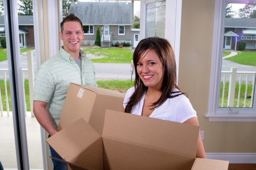 Packed moving boxes and furniture prepared for house removals in Creekmouth