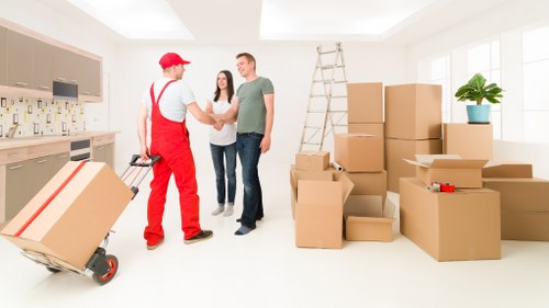 Professional movers loading items during a Creekmouth flat removal